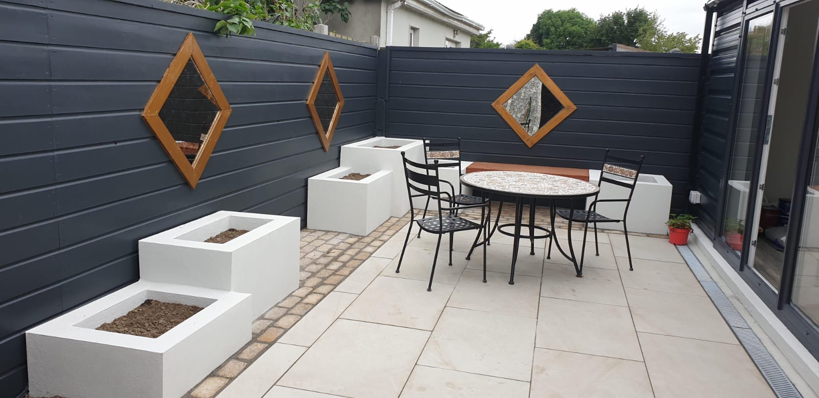 Outdoor patio with decorative mirrors