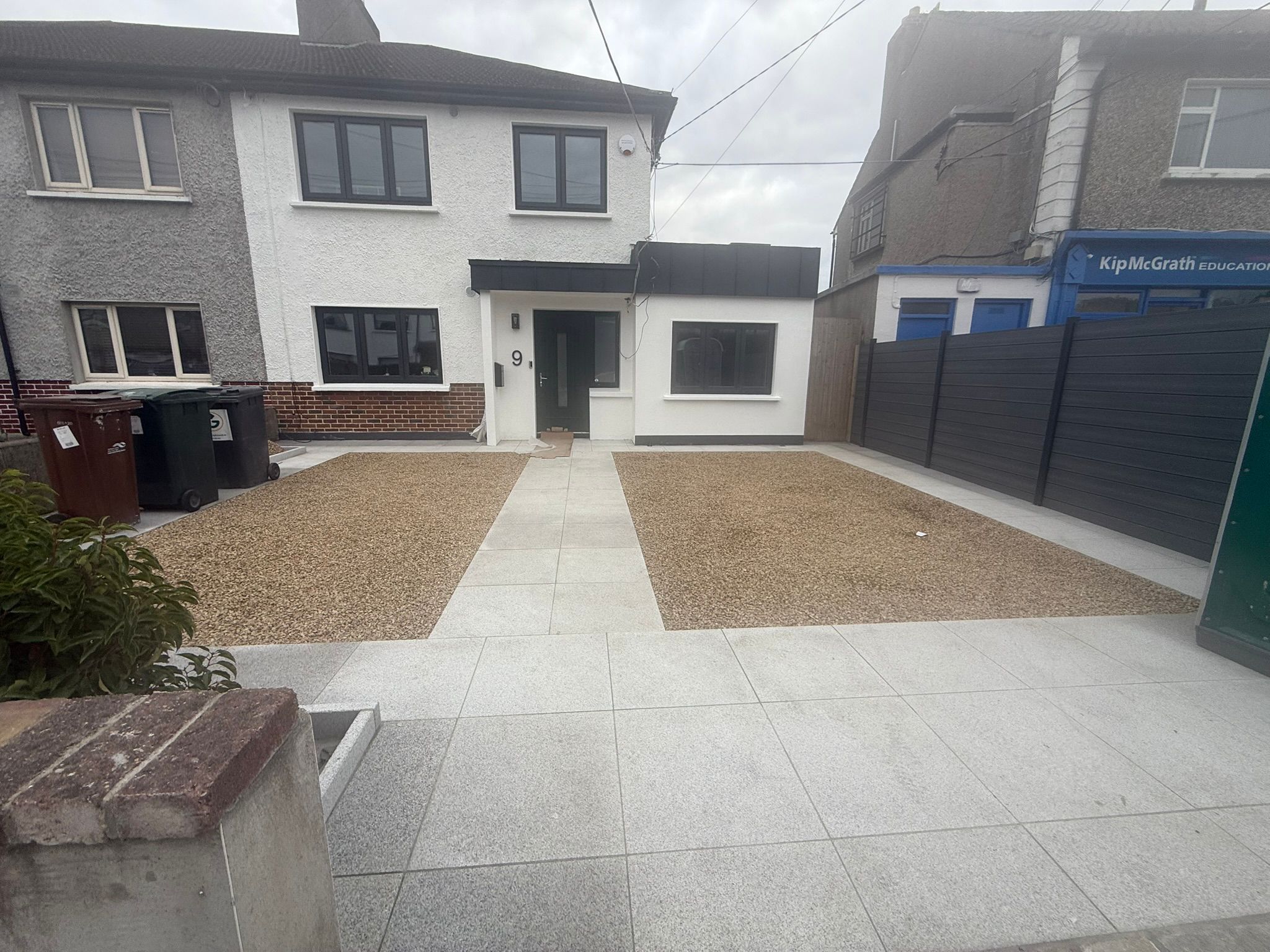 House exterior renovation with gravel driveway and rendered finish